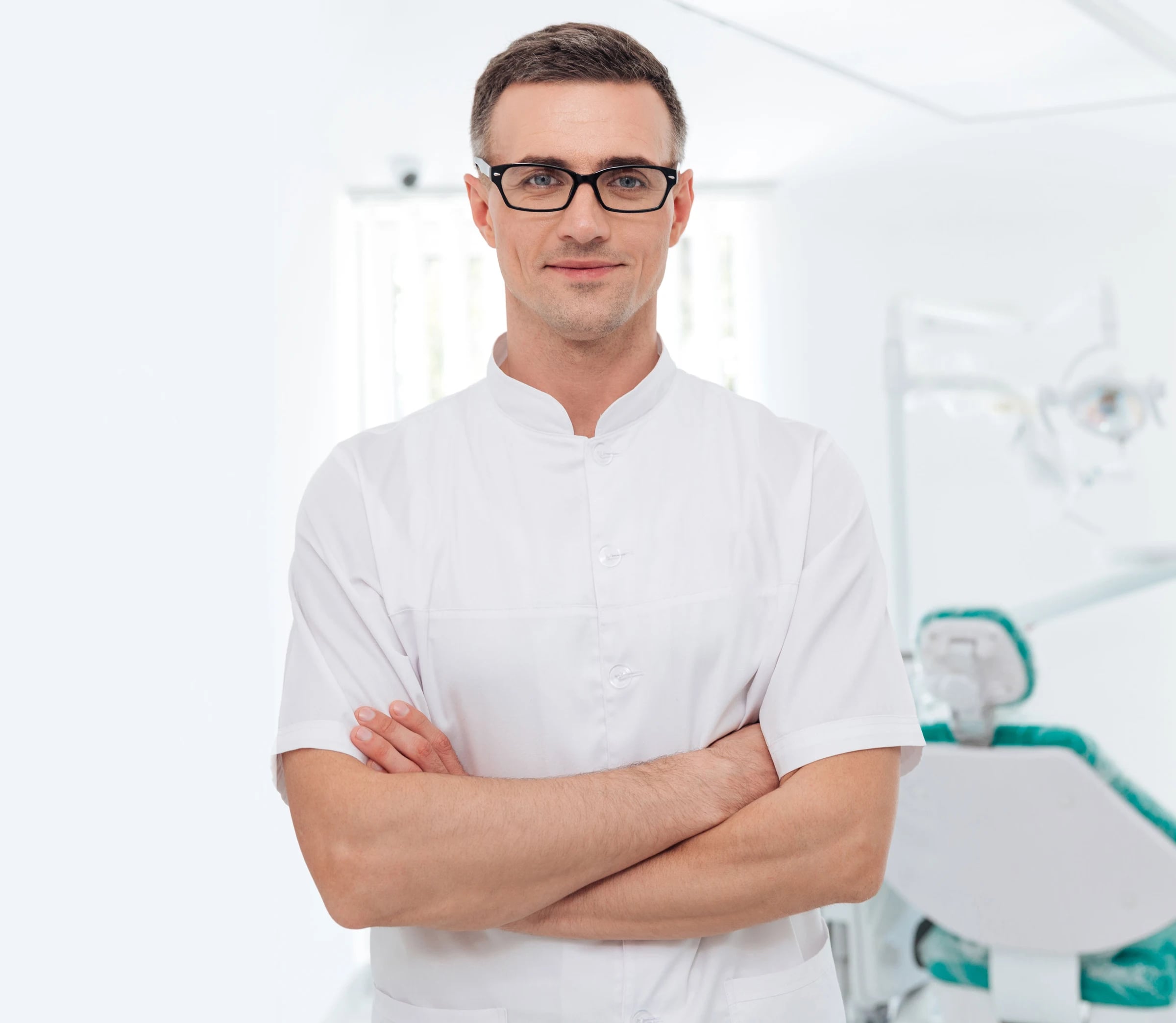 Dentist in a white coat standing in a dental clinic