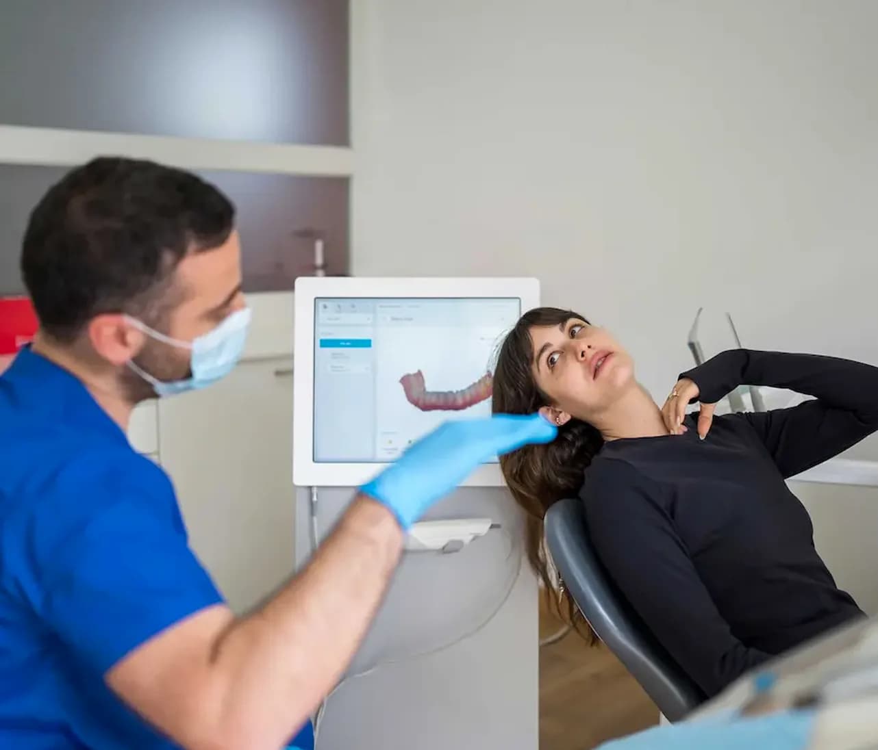 Dentist scanning a patient in the dental chair